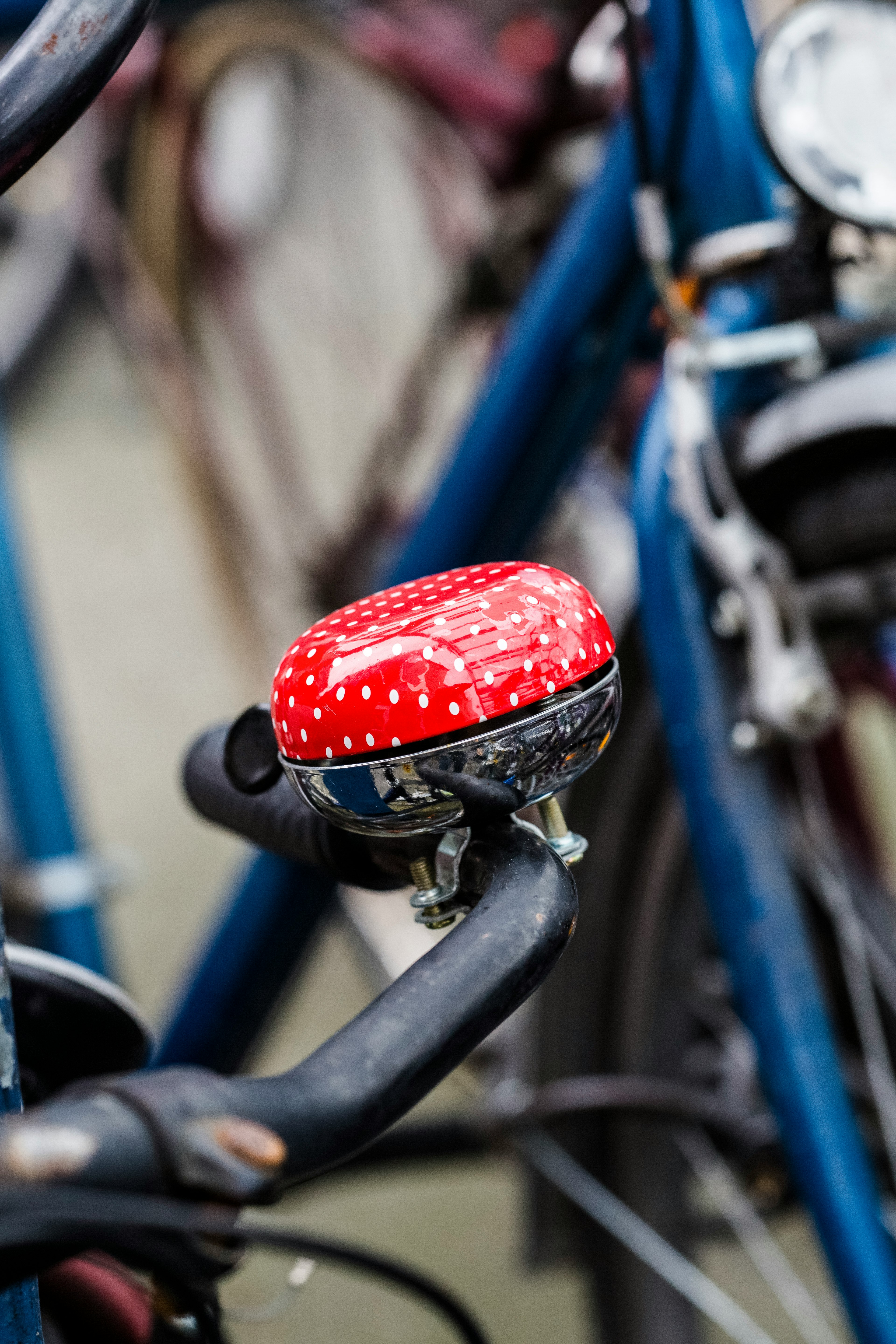 red and blue bicycle bell on black bicycle